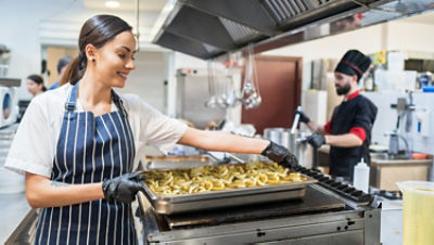 Female chef working in the hotel kitchen
